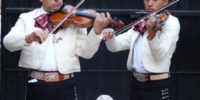 two mariachi musicians in traditional dress