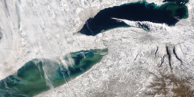 Lakes Erie and Ontario and the land around them covered in lake effect snow, as seen from space